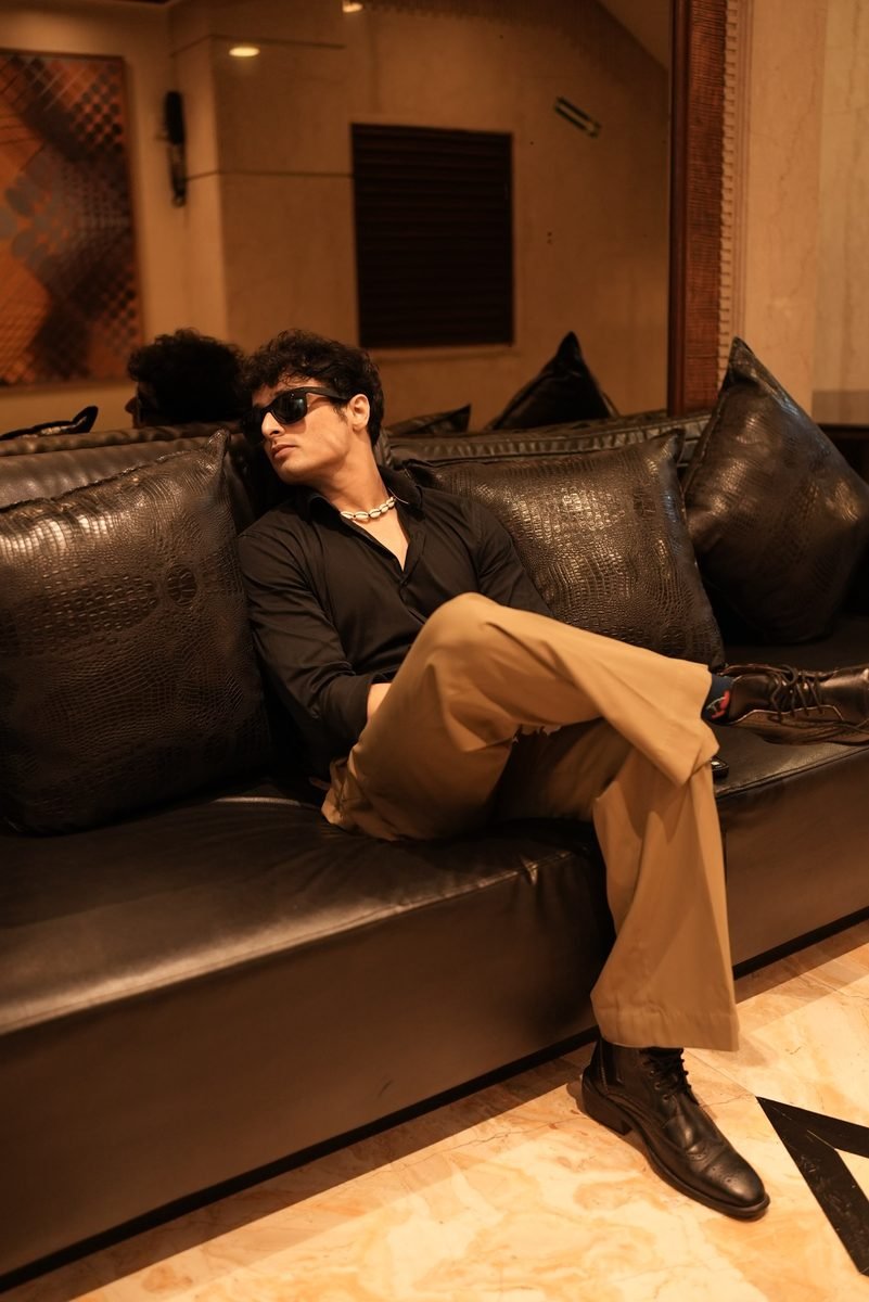 Arun Sharma, winner of MTV Roadies Real Heroes 2019, seated on a leather sofa in sunglasses and a black shirt